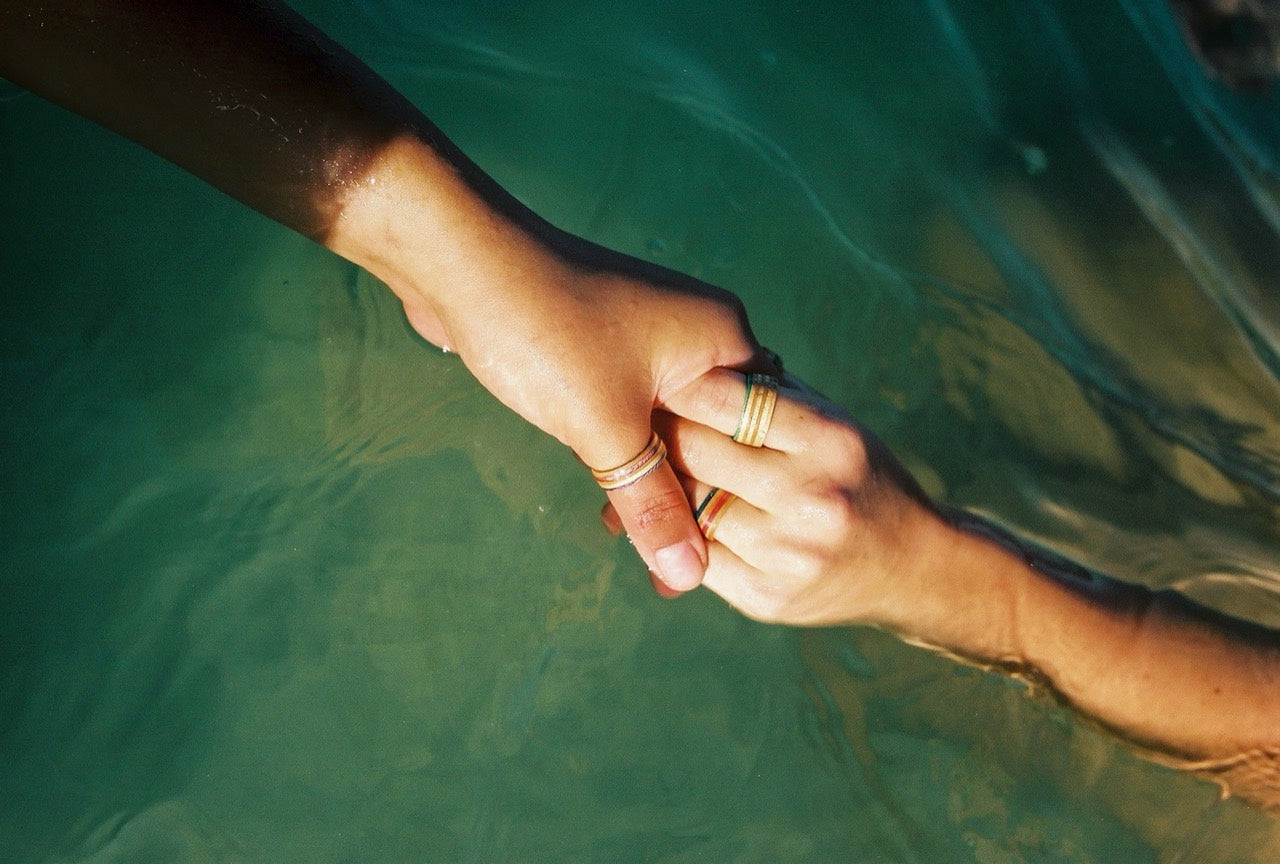 Hands wearing Rebirth rings underwater