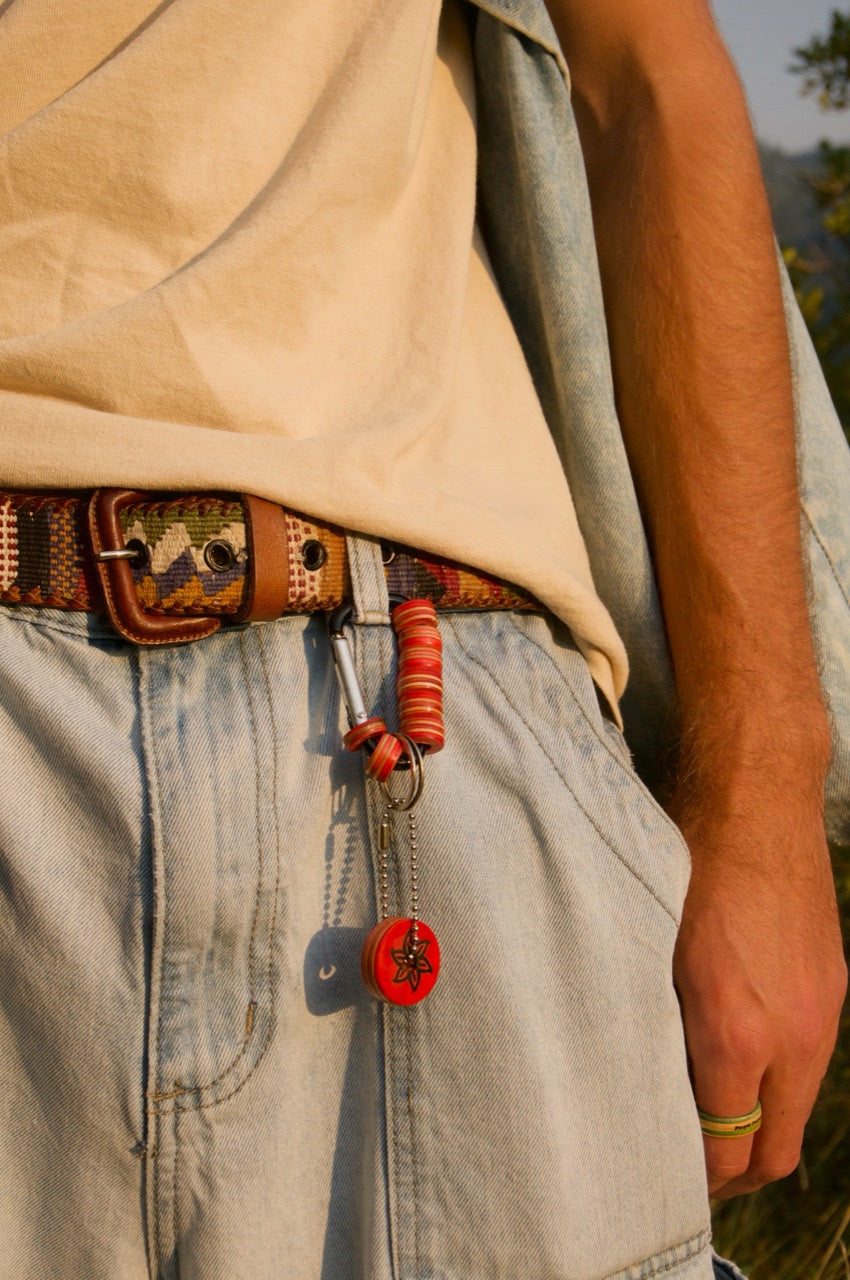 Rose Rebirth Carabiner Keychain close-up with recycled skateboard detail and charm