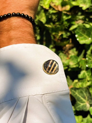Midnight Stack recycled skateboard cufflink on a white shirt cuff