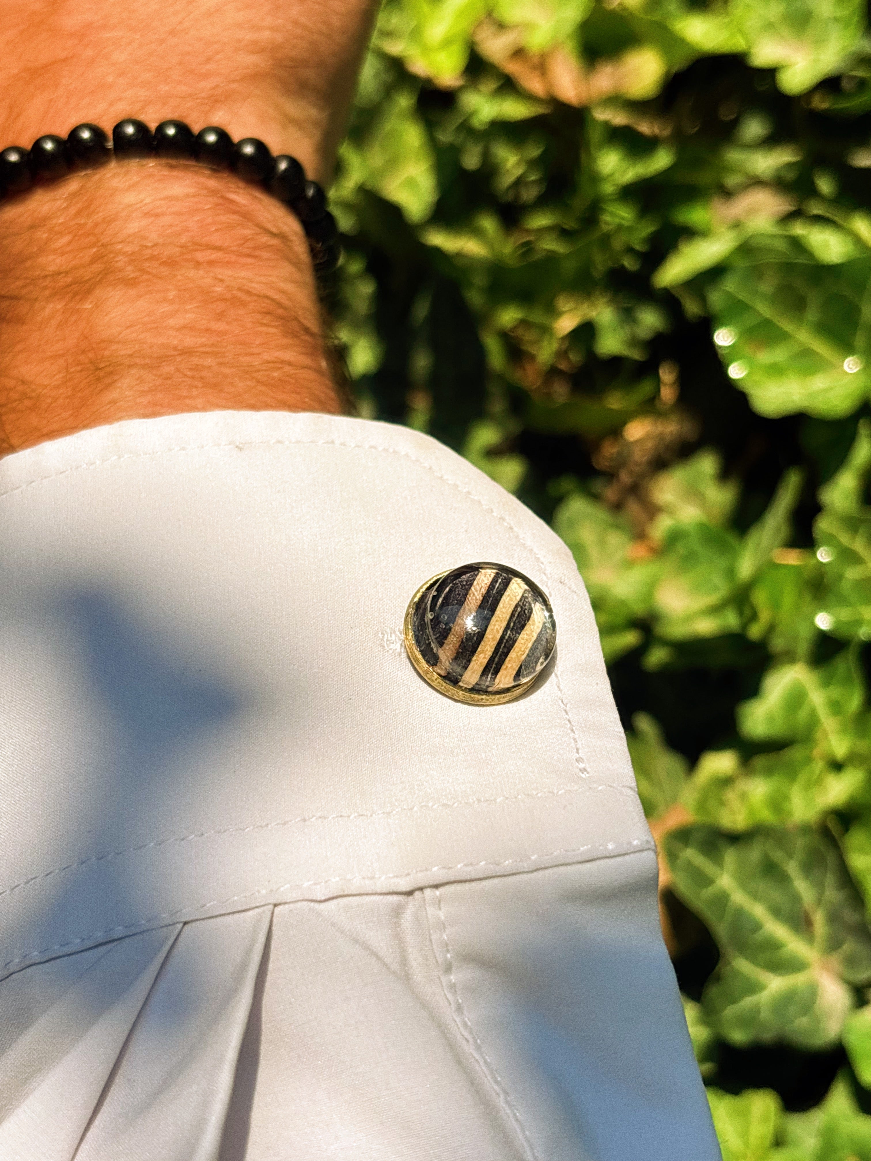 Midnight Stack recycled skateboard cufflink on a white shirt cuff